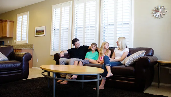 Joshua Becker, his wife, Kim, and their two kids on the couch in their living room